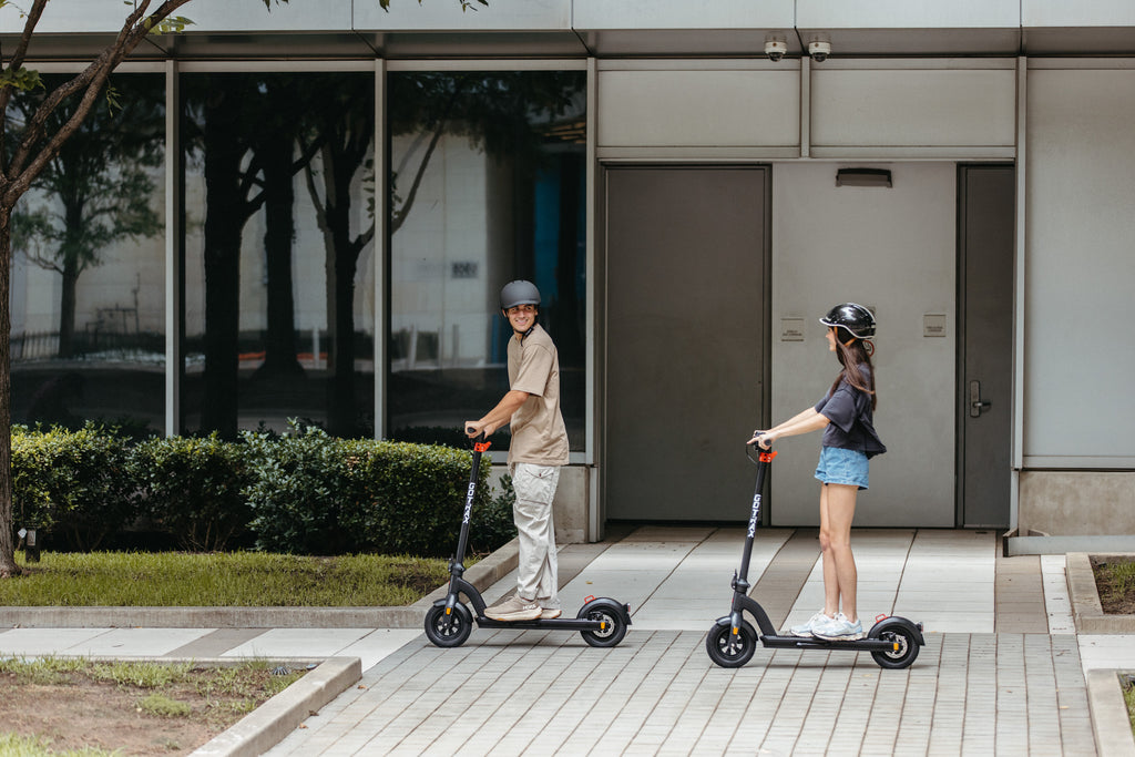 A man and a woman riding the GOTRAX G3 Max Long Range Electric Scooter