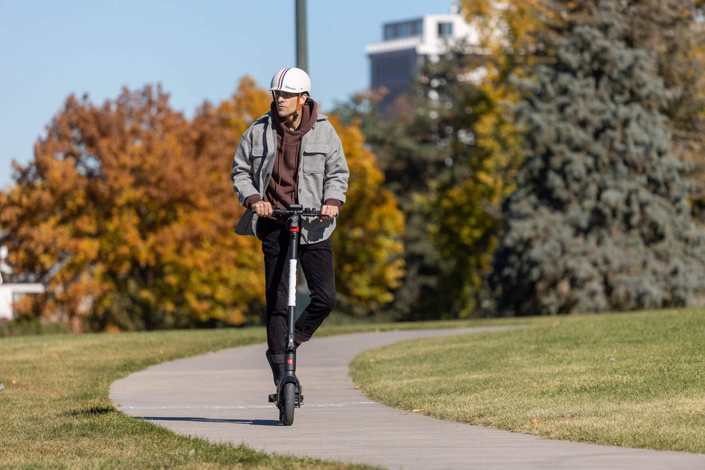 A man riding the GOTRAX G4 Electric Scooter for Adults